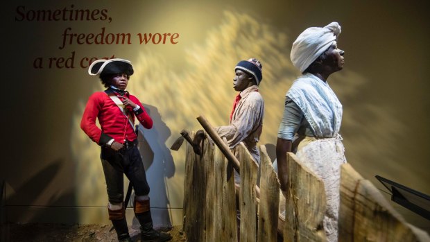 History setting: A 14-year-old London Pleasants, left, who left slavery by joining a Loyalist regiment encourages other slaves to flee to the British Army in search freedom, at the Museum of the American Revolution in Philadelphia.