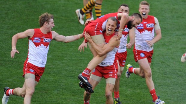 In the Nick of time: Swans players rush to congratulate Nick Malceski for his last-minute goal in the 2012 grand final.