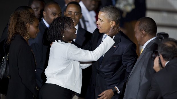 Warm welcome: US President Barack Obama embraces his half-sister Auma Obama at Jomo Kenyatta International Airport in Nairobi, as Kenyan president Uhuru Kenyatta (right) looks on.