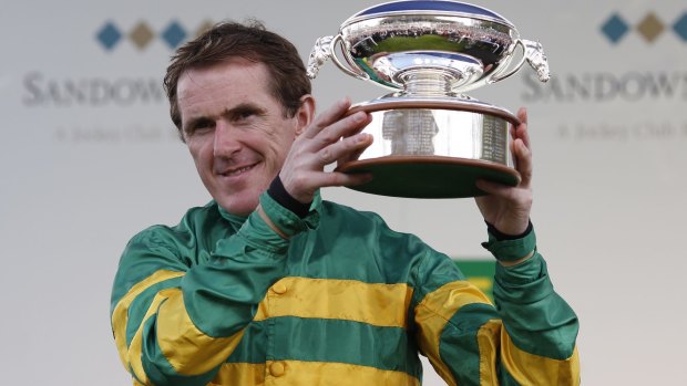 Winning feeling: Tony McCoy with the jockeys' championship trophy won for the 20th consecutive time on the day he retired in April 2015.