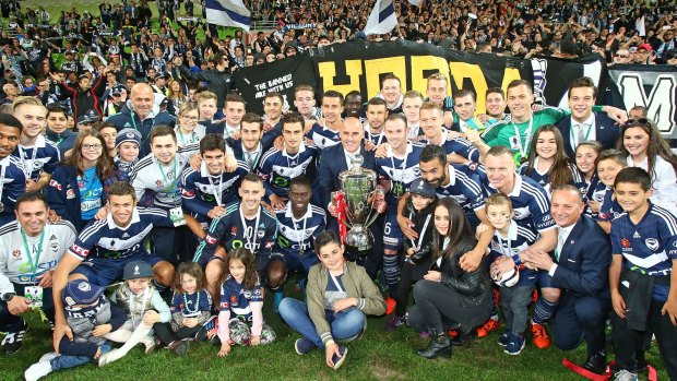 Trophy team: Coach Kevin Muscat and Victory players celebrate after being presented the FFA Cup.