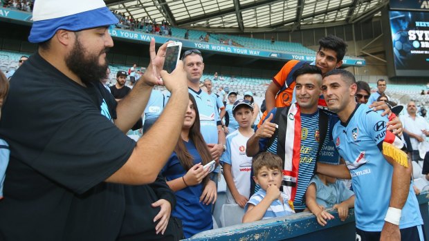 Warm reception: Ali Abbas poses with Sydney FC fans after the win over Newcastle Jets at ANZ Stadium.