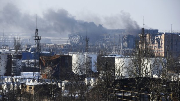 Smoke rises over the battered shell of Donetsk airport.