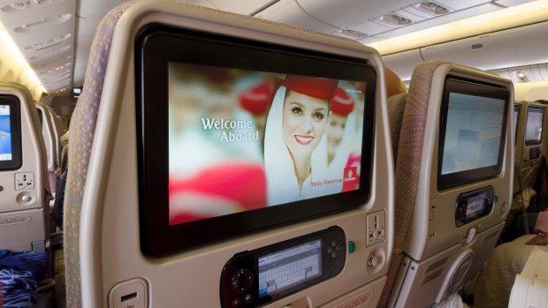 Entertainment system screens inside the cabin of a Emirates Boeing 777.