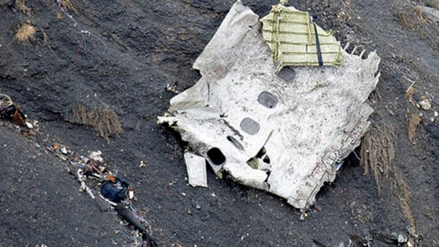 A rescue worker searches near a piece of fuselage among the debris at the crash site of an Airbus A320, near Seyne-les-Alpes. 