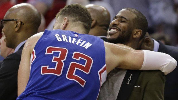 This one's for you: Los Angeles Clippers forwad Blake Griffin hugs injured teammate Chris Paul following game 1 in the second-round NBA playoff series against the Rockets in Houston. Los Angeles won 117-101. 
