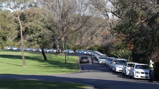 Comcars wait to pick-up the politicians after a swearing-in ceremony at Government House.