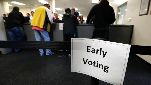 Local residents receive their ballots at the Polk County Election Office on the first day of early voting in Des Moines, Iowa last month.