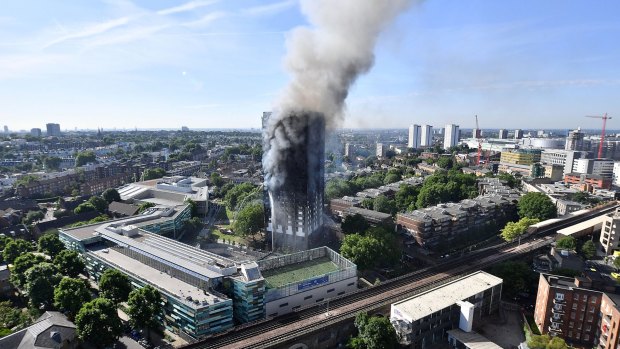 Smoke rises from Grenfell Tower in west London.