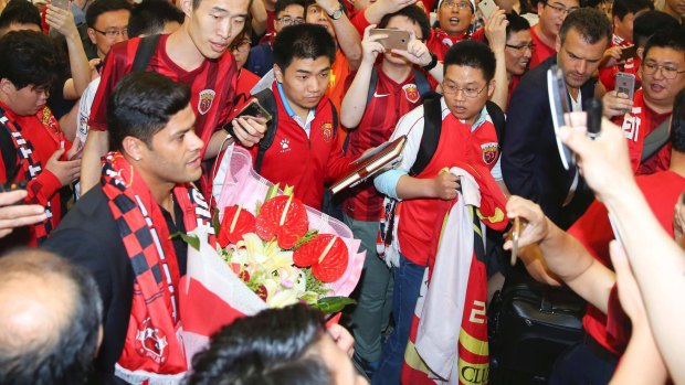 Worth weight in gold: Brazilian forward Hulk is surrounded by fans at the airport in Shanghai in June just before signing with Shanghai SIPG from Zenit St Petersburg for an Asia transfer record $62 million.