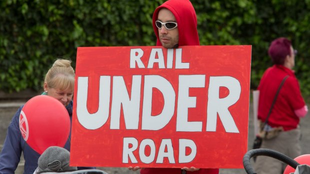A protester at a rally against a sky rail on the Frankston train line. 