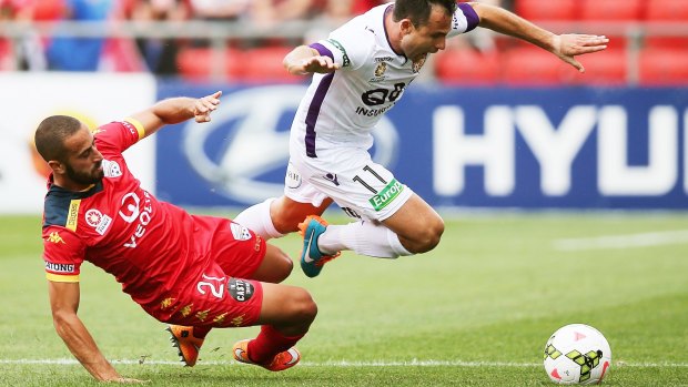 Back in the game: Tarek Elrich tackles Richard Garcia of Perth Glory.