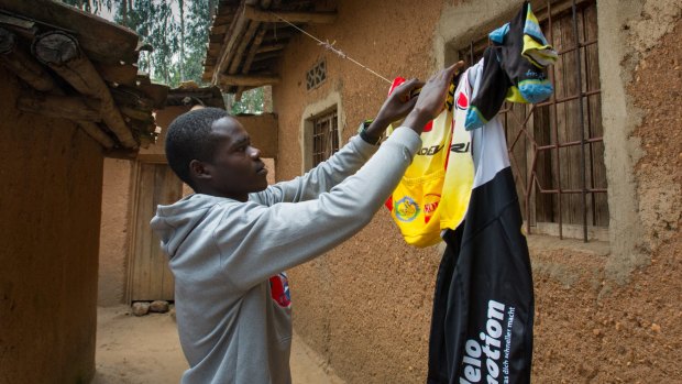 Jean-Eric Habimana hangs his cycling kit on the line outside his house in Rwanda.
