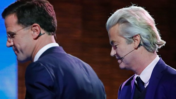 Right-wing populist leader Geert Wilders and Dutch Prime Minister Mark Rutte, left, leave the stage after a national televised debate.