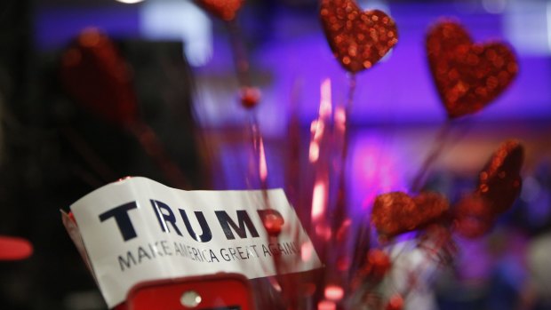 A Donald Trump supporter holds a "Trump" sign before Republican presidential candidate Donald Trump speaks in Mississippi on Monday.