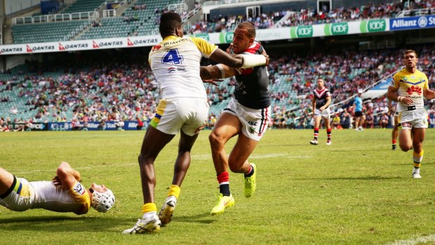 Try time: Roosters centre Blake Ferguson shrugs off opposite number Edrick Lee to score against the Canberra Raiders at Allianz Stadium.