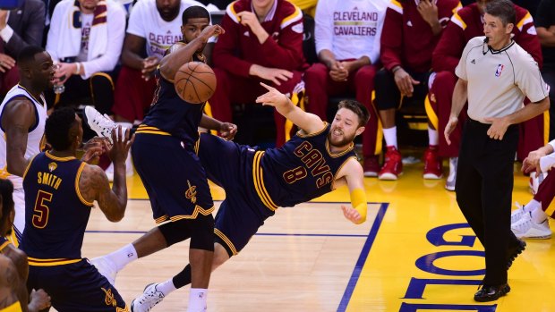 Hustle like Delly: Cavaliers guard Matthew Dellavedova goes horizontal to keep the ball inbounds against the Golden State Warriors.