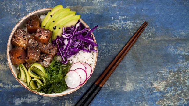 Hawaiian tuna poke bowl with seaweed, avocado, red cabbage slaw, radishes and black sesame seeds. 