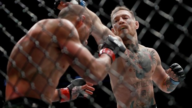 Conor McGregor punches Eddie Alvarez during the UFC 205 event at Madison Square Garden.