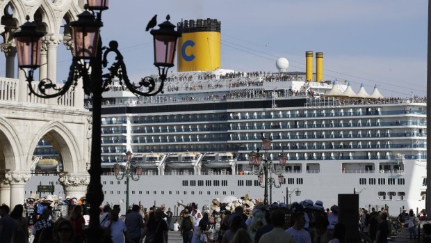 A cruise ship passes by St. Mark's Square in June, 2019.
