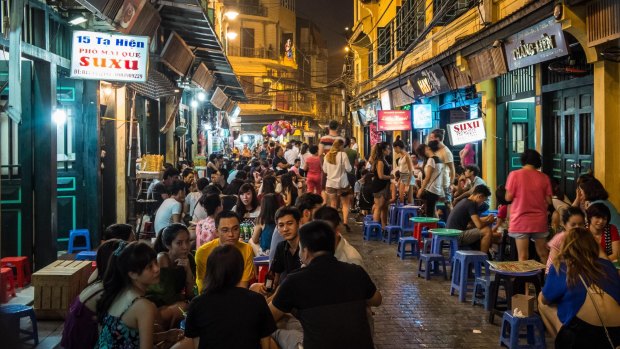 Tourists enjoying night life at Bia Hoi Beer Bars in the old quarter of Hanoi.