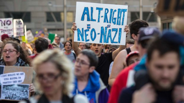 Protesters march outside a conference of the so-called alt-right in Washington.