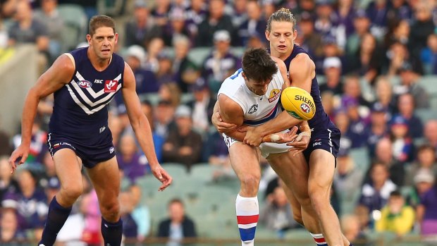 Nat Fyfe tackles Tom Campbell during the round three AFL match between the Fremantle Dockers and the Western Bulldogs at Domain Stadium.