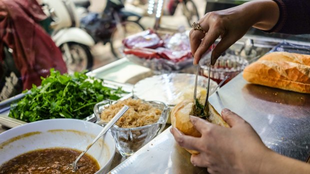 Tasting banh mi in Hanoi old town.