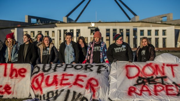 Students protest outside Parliament on Friday.