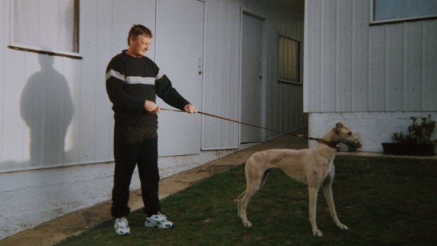 John Burrows, a local greyhound trainer, with Sandy, one of his greyhounds.
