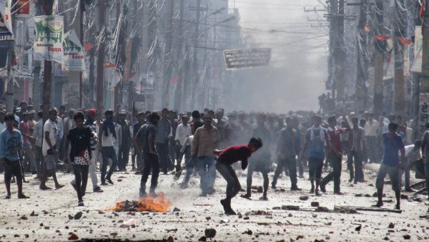 Ethnic Madhesi protesters throw stones and bricks at Nepalese policemen in Birgunj on November 2.