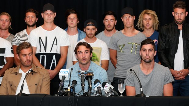 Watson is flanked by teammates as he addreses the media after the Essendon 34 were initially cleared by the AFL anti-doping tribunal.