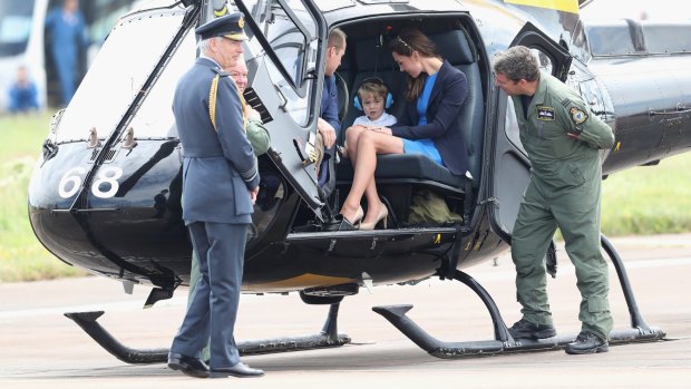 Prince William with the Duke and Duchess of Cambridge inside a Squirrel helicopter.