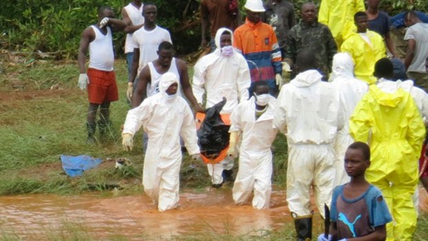 Rescue workers carry the body of a victim from the site of a mudslide in Regent, east of Freetown, Sierra Leone on Monday.