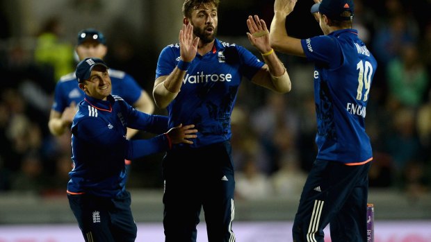 Too easy: Liam Plunkett celebrates with James Taylor and Chris Woakes after dismissing Pat Cummins.