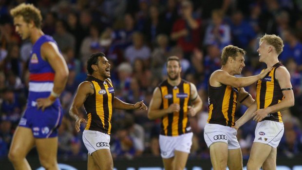 Cyril Rioli and Sam Mitchell celebrate the win with James Sicily who kicked the winning goal.