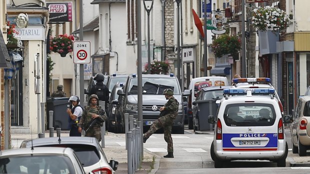 French soldiers stand guard near the scene of an attack in Saint-Etienne-du-Rouvray, Normandy, in July.