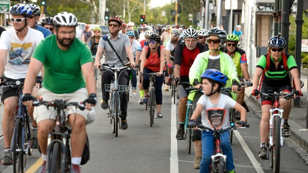 Cyclists ride along Sydney Road in a tribute to Alberto Paulon who was killed in a dooring incident one year ago on the road.