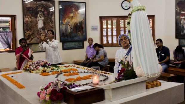 Worshippers gather around the tomb of Mother Teresa inside the Mother house in Kolkata, India.
