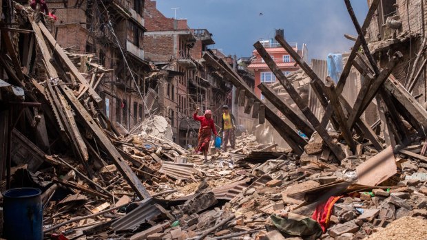 Nepalese victims of the earthquake search for their belongings among debris of their homes in Bhaktapur.