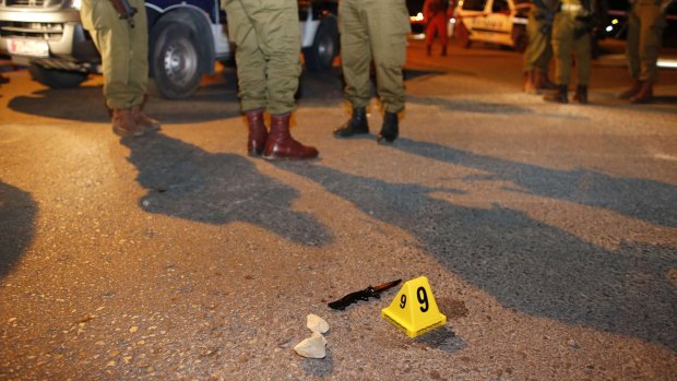 Israeli soldiers stand near a knife at the scene of a stabbing attack at the settlement of Alon Shvut in the Israeli-occupied West Bank.
