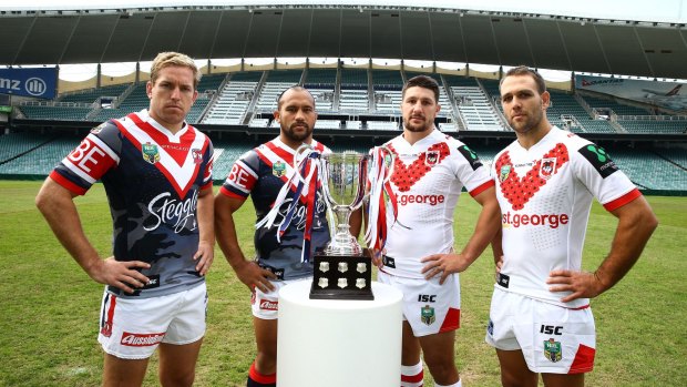 Traditional clash: Sydney Roosters players Mitch Aubusson and Sam Moa with St George Illawarra Dragons opponents Gareth Widdop and Jason Nightingale with the ANZAC day trophy.