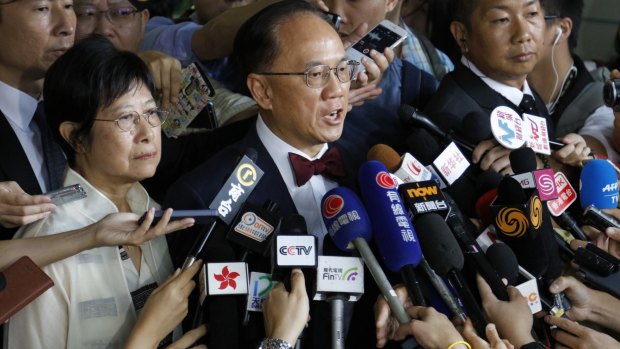 Donald Tsang, center, former leader of Hong Kong talks to reporters with his wife Selina as they leave a magistrate's court in Hong Kong on Monday.