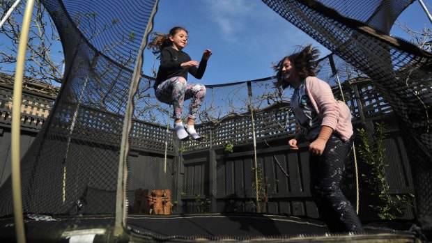 Eleven-year-old Mia Heffernan (left) and Stella Heffernan, 12, jump together