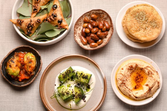 The opening flurry of snacks starring Turkish breads, hummus, and arak cucumbers.