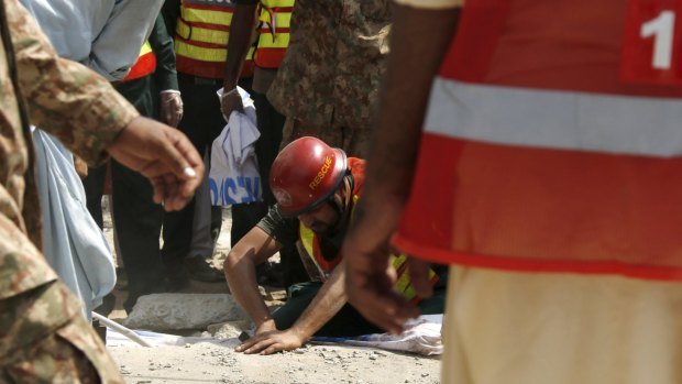 Rescue workers after the suicide attack that killed a leading Pakistani politician.
