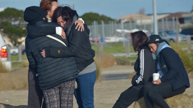 Distressed relatives of the three missing fishermen wait for news at Altona.
