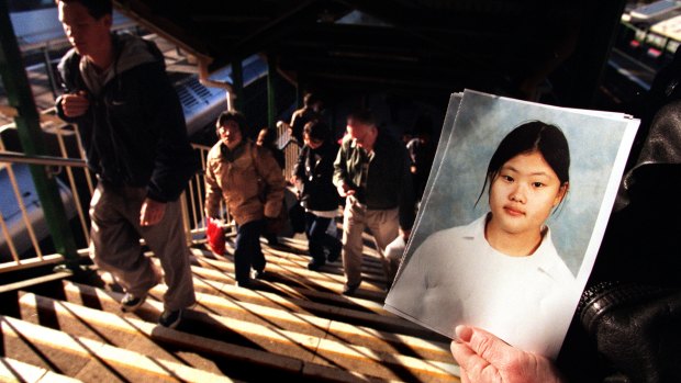 Authorities hand out photos of missing school girl Quanne Diec in 1998.