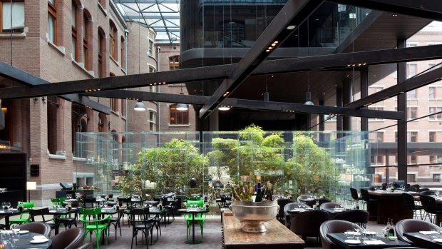 Relax in the brasserie at the Conservatorium hotel under its 42-metre high glass atrium.