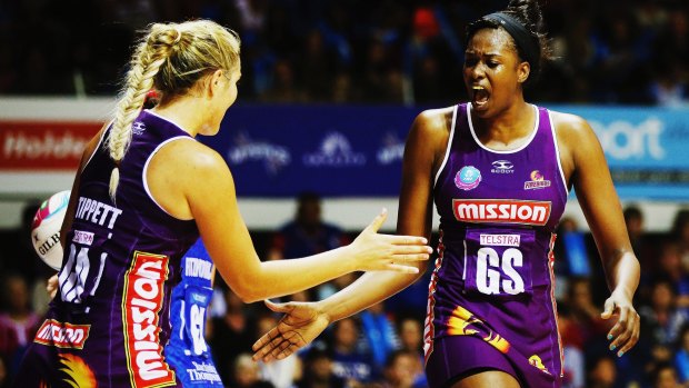 Gretel Tippett and Romelda Aiken of the Firebirds celebrate on their way to victory against the Northern Mystics.